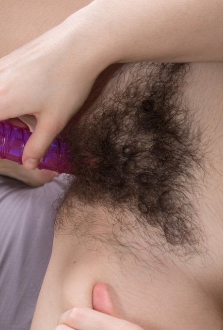 Dark haired teen girl Ole Nina inserts a dildo into her hairy vagina