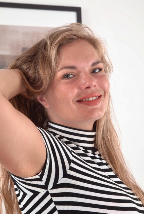 Thick amateur Ulrikke shows her tiny tits and hairy pits before parting bush