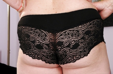 Plump granny with big tits takes off lingerie to expose her body
