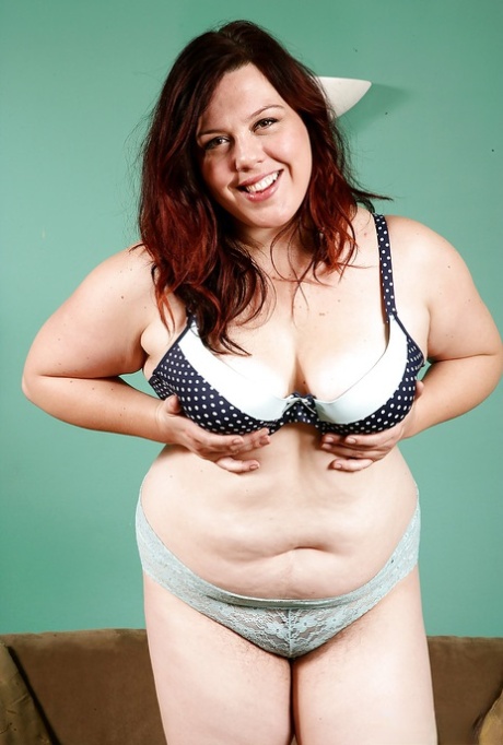 Mature overweight woman slides panties to one side to reveal hairy snatch