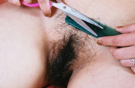 Asian amateur Junko folds back labia lips of hairy cunt after skirt removal