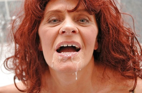 Lusty redhead granny sucks and fucks a hard cock in the bath