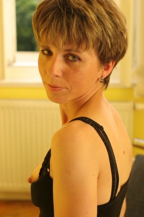 Sweet mature with short hair Zsofia rubs and toys her bushy twat