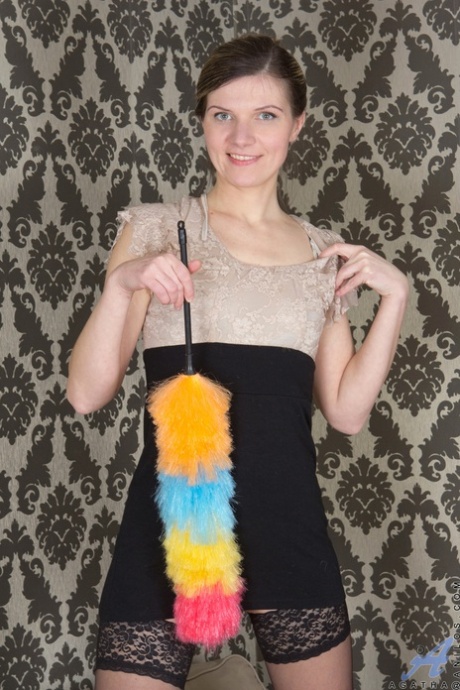 Slender maid Agatha displays her hairy crotch after cleaning the living room