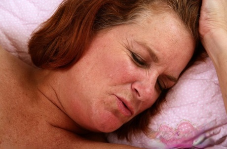 Chubby MILF Lucy A shows off her hairy pussy up close on her bed