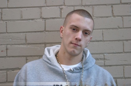 Shaved-headed stud Nick shows his inked body while masturbating on the bed