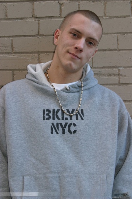Shaved-headed stud Nick shows his inked body while masturbating on the bed