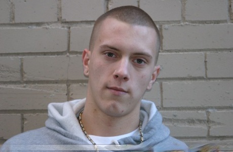 Shaved-headed stud Nick shows his inked body while masturbating on the bed