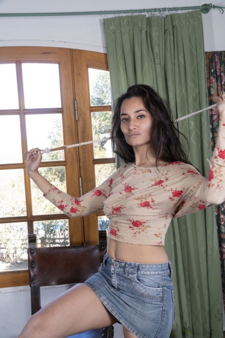 Sexy amateur girl Tiffany exposes her hairy armpits and cunt on a chair
