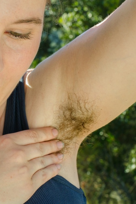 Amateur with big tits Eleanor Rose shows her hairy armpits and twat outdoors