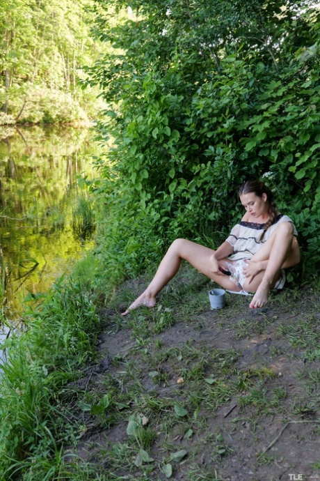 Naughty brunette Gabby Bella shaves and fingers her pussy outdoors