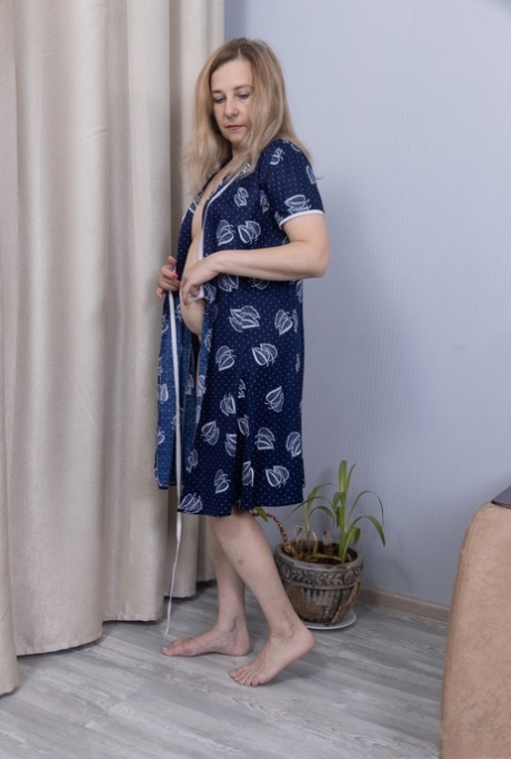 Mature blonde Laura Finiti undressing and toying her furry cunt